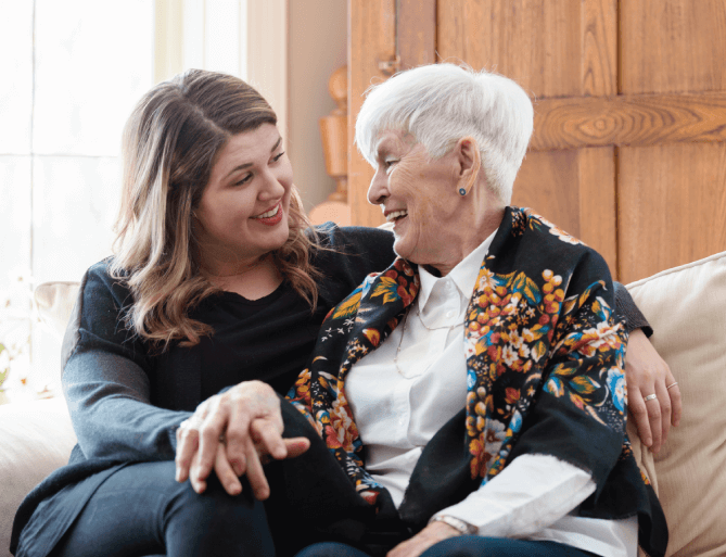 staff member visiting with senior woman