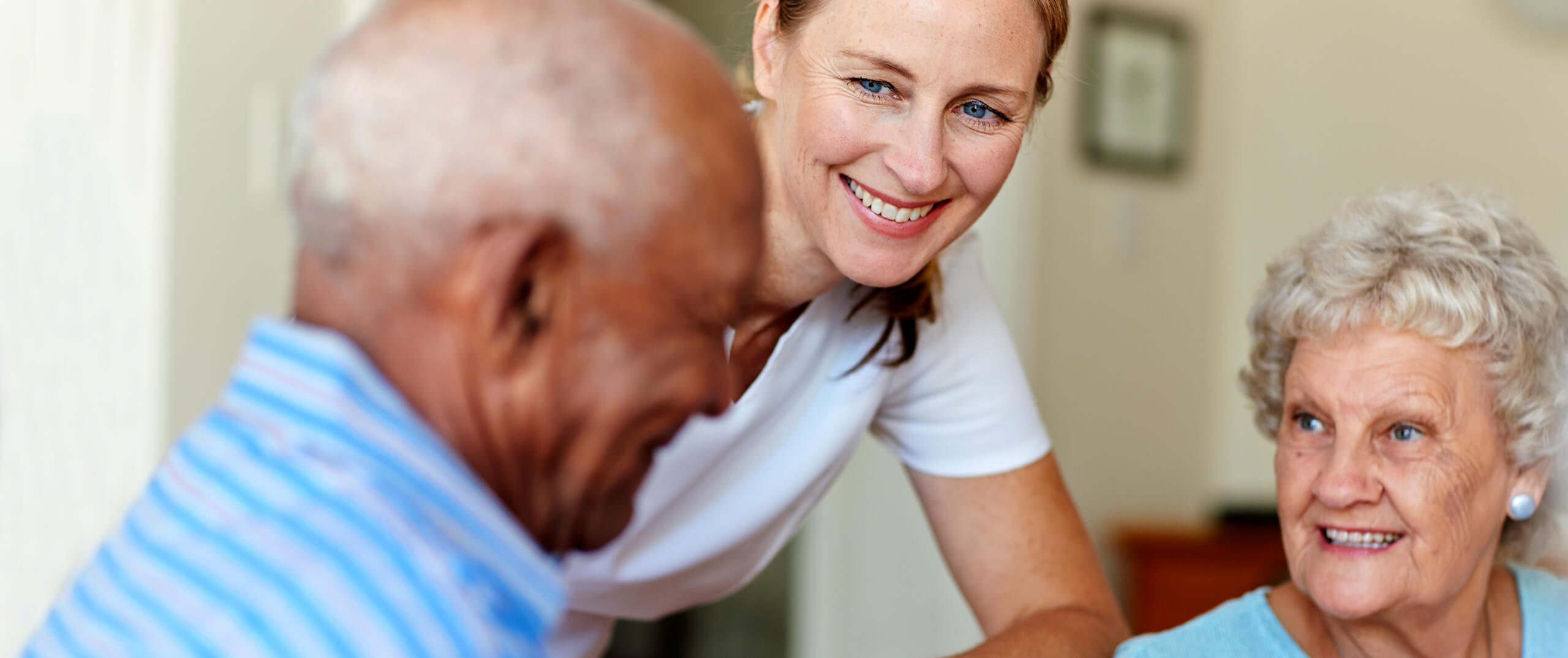 staff member checking with with senior couple